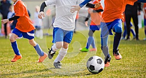 Running Children Football Soccer Players with Ball. Footballers kicking game photo