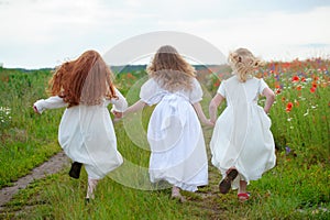 Running children outdoor. Three teenage girls runaway