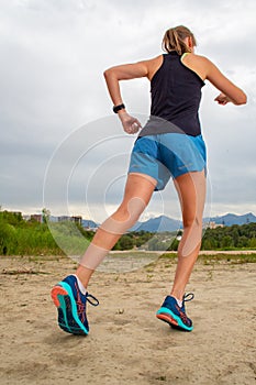 Running in city park. Woman runner outside jogging with Montreal skyline in background