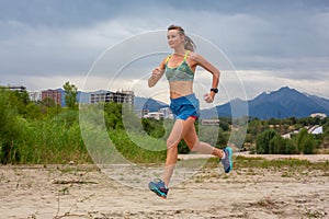 Running in city park. Woman runner outside jogging with Montreal skyline in background