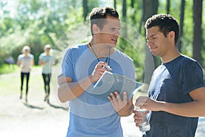 Running coach talking to athlete