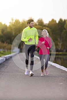 Running Concepts. Urban sports - couple jogging for fitness in the city on a beautiful autumn day