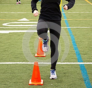 Running drills over orange cones