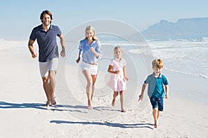 Running family at beach