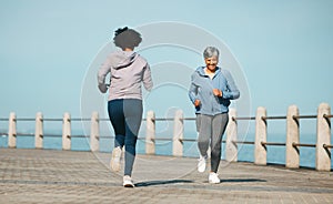 Running, fitness and senior friends by sea with mature women and smile from marathon. Exercise, workout and training on