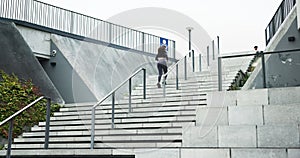 Running, fitness and stairs with woman in city for health, marathon training and challenge. Wellness, sports and workout