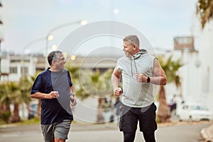 Running, friends and senior men in city for fitness, healthy lifestyle and outdoor wellness. Happy mature males, urban