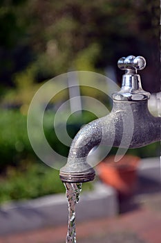 A running garden faucet tap