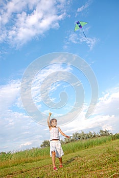 running girl playing with a kite