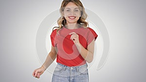 Running girl wearing red t-shirt and jeans Smiling on gradient b