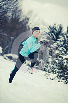 Running girl wearing sportswear, winter fitness