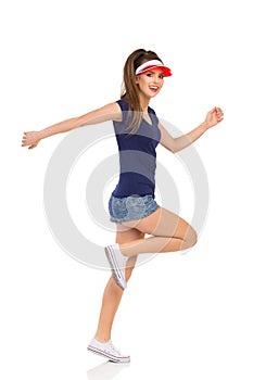 Running Happy Girl In White Sneakers And Sun Visor