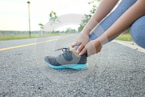 Running injury leg accident- sport woman runner hurting holding painful sprained ankle in pain