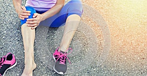 Running injury leg accident- sport woman runner hurting holding painful sprained ankle in pain.