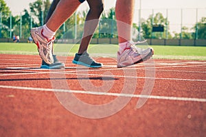 Running legs of white and black sportsmen