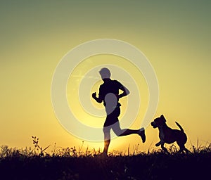 Running man with his dog sunset silhouettes