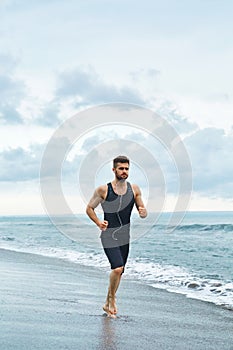 Running Man Jogging At Beach During Fitness Workout Outdoor. Sport