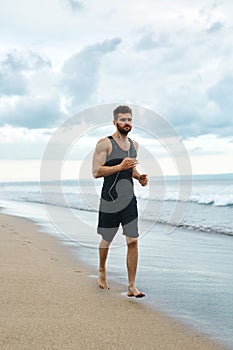 Running Man Jogging At Beach During Fitness Workout Outdoor. Sport