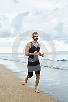 Running Man Jogging At Beach During Fitness Workout Outdoor. Sport