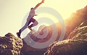 Running Man on Mountains jumping cliff over lake photo