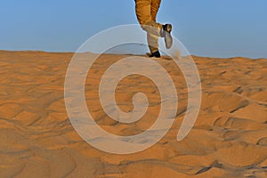 Running man on the sand in the desert as a background shot