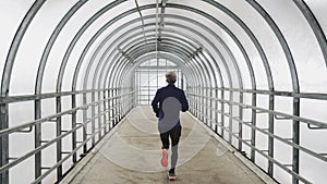 Running Man In Sportswear Workout Before Triathlon, Sprinting In Glass Tunnel.