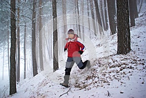 Running man in winter mountain forest