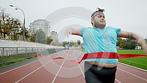 Running marathon for obese man he arrived at the finish line at the stadium happy and excited he stop to run