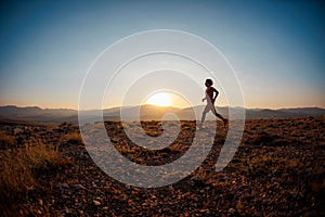 Running in the mountains.running athlete on the background of mountain peaks. Skyrunning. A person trains outdoors, leads an