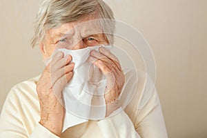 Running nose. An older woman has a stuffy nose or runny nose and is in fever