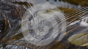 Running ripples on water surface with small rift