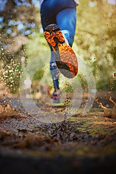 Running the roads less traveled. Cropped shot of a mans legs as hes running along a nature trail.