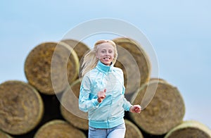 The running romantic girl outdoors against hay stack