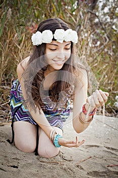 Running sand through her fingers