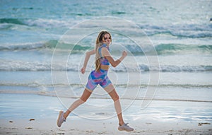 Running sexy woman jogging on beach. Fit woman doing workout on sea sand summer beach. Summer sport. Fitness female