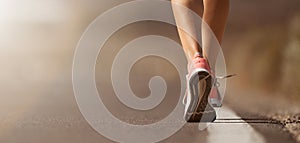 Running shoe closeup of woman running on road