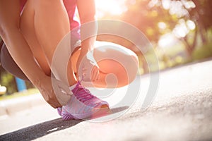 Running shoes - closeup of woman tying shoe laces. Female sport