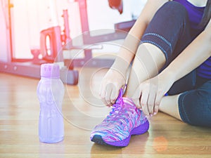 Closeup of woman tying shoe laces. Female sport fitness runner getting ready for jogging