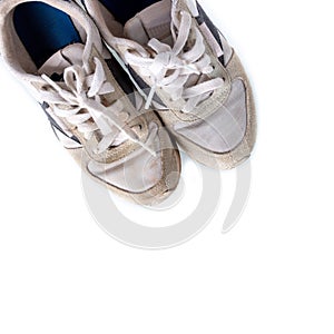 Running shoes are dirty and old after running isolated on white background.
