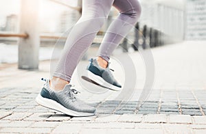 Running shoes, feet sneakers and city cardio exercise, marathon and sports training in urban outdoor. Closeup woman