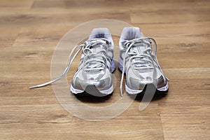 Running shoes on a gym floor after workout