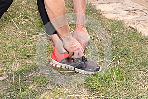 Running shoes runner woman tying laces during jogging girl exercise  for heath and fitness