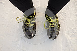 Running shoes with spikes on snow.