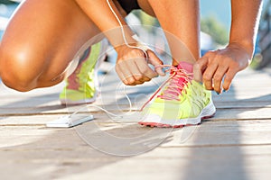 Running shoes - woman tying shoe laces