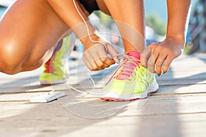 Running shoes - woman tying shoe laces