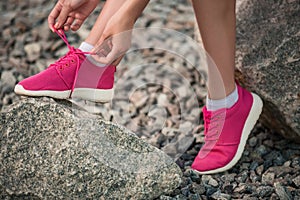 Running shoes - woman tying shoe laces.