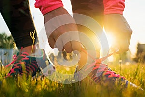 Running shoes - woman tying shoe laces