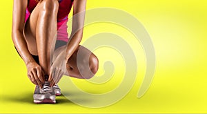 Running shoes - woman tying shoe laces. Closeup of female sport fitness runner