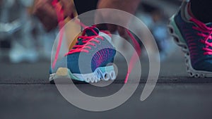 Running shoes - woman tying shoe laces in the gym