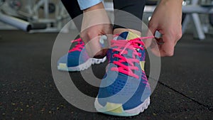Running shoes - woman tying shoe laces in the gym
